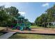 Community playground featuring multiple slides, swings, and climbing structures on a sunny day at 14612 Corkwood Dr, Tampa, FL 33626