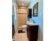 Bathroom featuring light blue walls, dark vanity, and a granite countertop at 1462 Highfield Dr, Clearwater, FL 33764