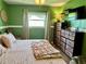 Comfortable bedroom with a king-size bed, dark wood dresser, and cozy decor at 1462 Highfield Dr, Clearwater, FL 33764