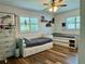 Bright bedroom featuring two beds, wood flooring, and decorated with modern decorations and a ceiling fan at 1462 Highfield Dr, Clearwater, FL 33764