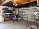 Spacious garage with ample storage, including shelving units and a modern garage door at 1462 Highfield Dr, Clearwater, FL 33764