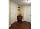 Hallway with hardwood floors and a small table between two white doors at 1462 Highfield Dr, Clearwater, FL 33764