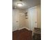 Hallway with wood floors, featuring a decorative wall hanging and two white doors at 1462 Highfield Dr, Clearwater, FL 33764