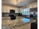 Kitchen with granite countertops, stainless steel appliances, and white cabinets at 1462 Highfield Dr, Clearwater, FL 33764