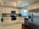 Modern kitchen featuring stainless steel appliances, granite countertops, and ample cabinet space for storage and food prep at 1462 Highfield Dr, Clearwater, FL 33764
