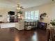 Spacious living room featuring hardwood floors, bright windows, ceiling fan, and comfortable seating area with natural light at 1462 Highfield Dr, Clearwater, FL 33764