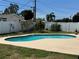 Refreshing backyard pool with a surrounding patio and privacy fence, ideal for outdoor relaxation and fun at 1462 Highfield Dr, Clearwater, FL 33764
