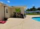 Exterior view of a backyard with a pool, lounging chairs, and plenty of space for outdoor activities and entertainment at 1462 Highfield Dr, Clearwater, FL 33764