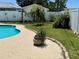 Pool area featuring privacy fencing, lush landscaping, and mature plants, creating a serene outdoor retreat at 1462 Highfield Dr, Clearwater, FL 33764