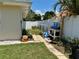 Functional side yard with a potting station and a stone paver path, ideal for gardening enthusiasts at 1462 Highfield Dr, Clearwater, FL 33764