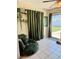 Bright sun room featuring tile floors, lush plants, and sliding glass doors to the backyard at 1462 Highfield Dr, Clearwater, FL 33764