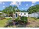 Landscaped backyard featuring a dining patio, pergola, and green lawn at 1529 Essex N Dr, St Petersburg, FL 33710