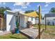 Cozy backyard deck with grill, shade covering, and lush landscaping at 1529 Essex N Dr, St Petersburg, FL 33710