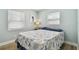 Comfortable bedroom with a queen size bed, light walls, and beach-themed decor at 1529 Essex N Dr, St Petersburg, FL 33710