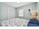 Bright bedroom with a closet, window, sea horse art and a queen sized bed at 1529 Essex N Dr, St Petersburg, FL 33710