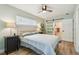 Bedroom with a comfortable queen bed, wood floors, and a sliding barn door to the bathroom at 1529 Essex N Dr, St Petersburg, FL 33710