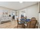 Charming dining area with wicker chairs, glass table, and hardwood floors at 1529 Essex N Dr, St Petersburg, FL 33710