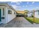 Long driveway with a shade sail covering, leading to a back yard pergola at 1529 Essex N Dr, St Petersburg, FL 33710