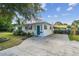 The house has a long driveway leading to a covered parking area with a black fence at 1529 Essex N Dr, St Petersburg, FL 33710