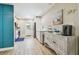 Spacious kitchen with white cabinets, stainless appliances, and modern decor with wooden flooring at 1529 Essex N Dr, St Petersburg, FL 33710