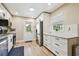Well-lit kitchen featuring stainless steel appliances, white cabinetry and granite countertops at 1529 Essex N Dr, St Petersburg, FL 33710