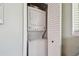 Space-saving laundry closet with stacked washer and dryer, and white louvered doors at 1529 Essex N Dr, St Petersburg, FL 33710