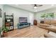 Bright living room features wood-look floors, comfortable seating, and an entertainment center at 1529 Essex N Dr, St Petersburg, FL 33710