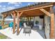 Comfortable outdoor patio with a wooden pergola, seating, and lush landscaping at 1529 Essex N Dr, St Petersburg, FL 33710