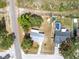 Aerial view of the home with a pool, landscaped yard, and street access at 1569 Larkin Rd, Spring Hill, FL 34608
