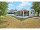 This home features a charming screened-in porch and a well-sized yard at 1569 Larkin Rd, Spring Hill, FL 34608