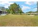 This home features a charming screened-in porch and a well-sized yard at 1569 Larkin Rd, Spring Hill, FL 34608