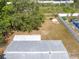 Expansive backyard is partially fenced in and includes mature trees and landscaping at 1569 Larkin Rd, Spring Hill, FL 34608