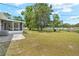 This home features a charming screened-in porch and a well-sized yard at 1569 Larkin Rd, Spring Hill, FL 34608
