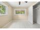 This bright bedroom has tile floors, a large window and a closet space at 1569 Larkin Rd, Spring Hill, FL 34608
