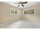 Bright bedroom features tile flooring and two windows allowing for plenty of natural light at 1569 Larkin Rd, Spring Hill, FL 34608