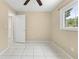 Bedroom with tile floors, bright window, closet space and neutral walls provides a serene and inviting atmosphere at 1569 Larkin Rd, Spring Hill, FL 34608