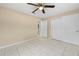 Bedroom features a ceiling fan, closet and natural light from window at 1569 Larkin Rd, Spring Hill, FL 34608