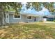 Cozy single-story home with a well-maintained lawn and mature trees in the yard at 1569 Larkin Rd, Spring Hill, FL 34608