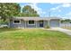 Charming single-story home featuring a well-kept lawn and inviting entrance at 1569 Larkin Rd, Spring Hill, FL 34608