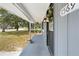 Close-up of a home's charming covered front porch and front door at 1569 Larkin Rd, Spring Hill, FL 34608