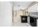 Bright eat-in kitchen view, with adjacent living area, updated cabinets and flooring at 1569 Larkin Rd, Spring Hill, FL 34608