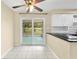 Eat-in kitchen with tile floor and sliding glass doors to a screened porch at 1569 Larkin Rd, Spring Hill, FL 34608