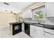 Cozy kitchen features updated appliances, granite countertops, and plenty of sunlight at 1569 Larkin Rd, Spring Hill, FL 34608