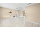 Spacious living room with tile floors, a ceiling fan, and bright neutral walls at 1569 Larkin Rd, Spring Hill, FL 34608