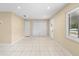 Bright living room featuring tile flooring, neutral paint and closet space at 1569 Larkin Rd, Spring Hill, FL 34608