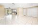 Bright, open-concept layout with tile floors and access to the kitchen area at 1569 Larkin Rd, Spring Hill, FL 34608