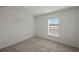 Bright, carpeted bedroom with a large window and neutral paint at 21523 Chipman Ave, Port Charlotte, FL 33954