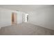 Carpeted bedroom with an ensuite bathroom and doorway access to other living areas at 21523 Chipman Ave, Port Charlotte, FL 33954