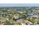 Scenic aerial view highlights the house's waterfront location with canal access, surrounded by lush greenery at 216 High St, Tarpon Springs, FL 34689