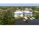 Aerial view of two beautiful waterfront homes with docks, boatlifts, and landscaped yards at 216 High St, Tarpon Springs, FL 34689